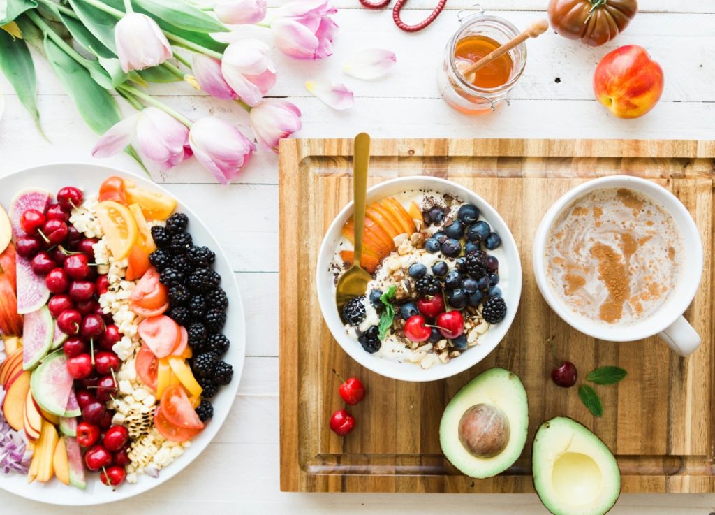 fresh fruits and oatmeal on a wooden cutting board